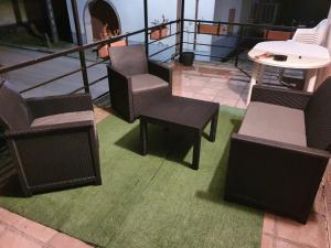 a group of chairs and tables on a balcony at Appartement F1 rez de chausser BG N°2 in Bains-les-Bains