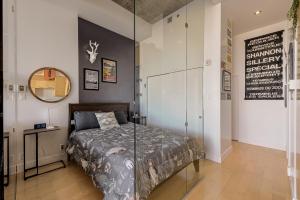 a bedroom with a bed with a glass wall at Les Immeubles Charlevoix - Le 760108 in Quebec City