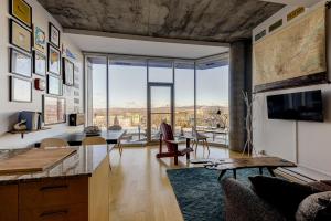 a living room with a view of a city at Les Immeubles Charlevoix - Le 760108 in Quebec City