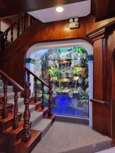 a large aquarium in theoyer of a house with stairs at Hotel Las Palmas in Lima