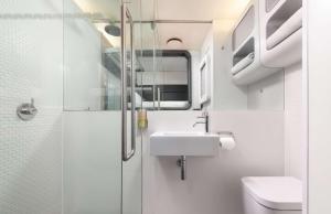 a small bathroom with a sink and a toilet at YOTELAIR London Gatwick Airport in Horley