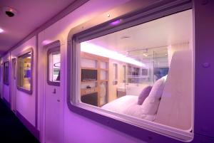 a room with a window with a bed in it at YOTELAIR London Gatwick Airport in Horley
