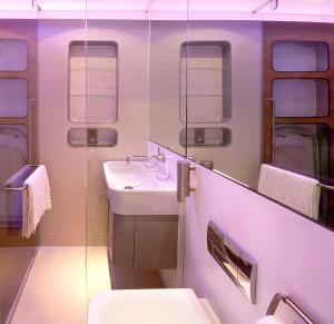 a bathroom with a sink and a toilet at YOTELAIR London Gatwick Airport in Horley