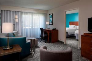 a hotel room with a bed and a desk at Sonesta Select Boca Raton Town Center in Boca Raton