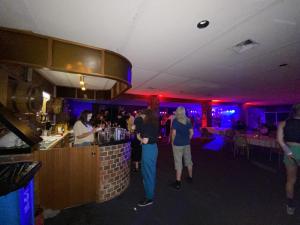 a group of people standing at a bar at Charlton Motel in Charlton +47 photos