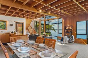 a kitchen and living room with a table and chairs at Wai Marino - Taupo in Taupo