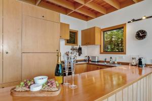 a kitchen with a counter with a bottle of wine at Wai Marino - Taupo in Taupo