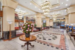 a lobby with a vase of flowers on a table at The Grace Hotel in Sydney