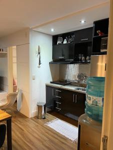 a kitchen with black cabinets and a counter top at Flat Mar Vip in Fortaleza