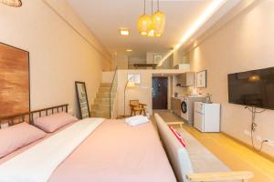 a bedroom with a large bed and a tv at Locals Apartment House 17 in Jiang'an