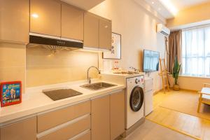 a kitchen with a sink and a washing machine at Locals Apartment House 17 in Jiang'an
