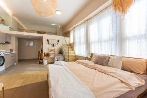 a bedroom with a large bed and a staircase at Locals Apartment Inn 16 in Jiang'an