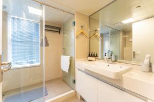 a bathroom with a sink and a shower and a mirror at Locals Apartment Inn 16 in Jiang'an +23 photos