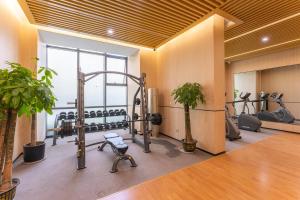 a gym with exercise equipment in a room at Locals Apartment House 39 in Jiang'an