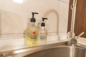 two bottles of cleaning products sitting next to a sink at Locals Apartment House 39 in Jiang'an +25 photos