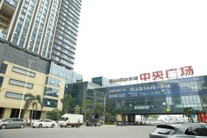 a city with cars parked in front of a building at Locals Apartment Place 44 in Zhanjiang