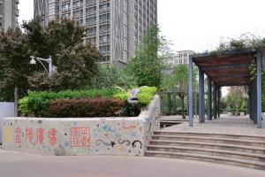 a park with a bench and stairs in a city at Locals Apartment House 90 in Tianjin
