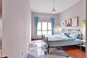 a bedroom with a bed and a window at Locals Apartment House 90 in Tianjin