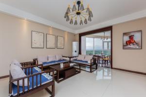a living room with chairs and tables and a chandelier at Locals Apartment House 01 in Changliu