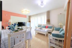 a living room with a couch and a table at Locals Apartment Inn 14 in Tianjin