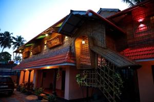 a building with a staircase on the side of it at CANALVIEW PRIVATE COTTAGE Azhikkal Ayiram Thengu in Perinād
