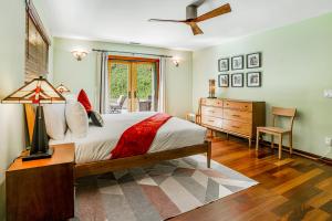 a bedroom with a bed and a dresser and a window at Hillcraft House Fantastic coastal home near beach w/electric car charging station & gas grill in Eden Gardens