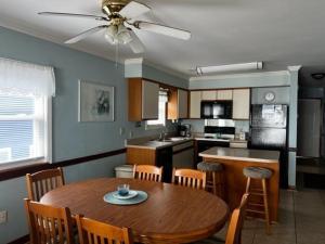 a kitchen with a wooden table and a dining room at Boston Commons 201 Condo in Myrtle Beach