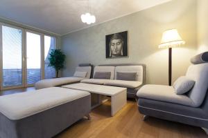 a living room with a couch and a table at Spa Resort Luxury Apartments in Budva