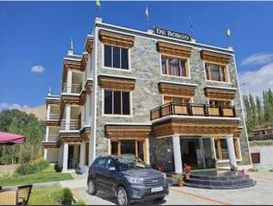 a car parked in front of a building at Hotel de borgo in Leh