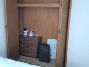 a bedroom with a bed and a dresser with a speaker at Maison Ota Building A Building B - Vacation STAY 11140 in Takamatsu