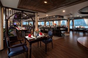 a restaurant with tables and chairs in a room at La Casta Regal Cruise in Ha Long