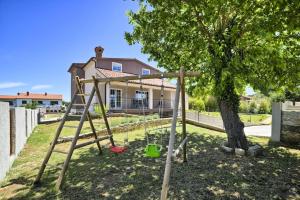 a swing set in front of a tree at Stylish & luxury villa with pool, biliard, extra pool heating available in Pula