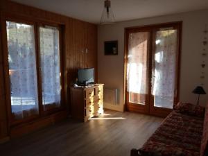 a living room with a tv and two windows at Appartement Valloire, 3 pièces, 8 personnes - FR-1-263-455 in Valloire