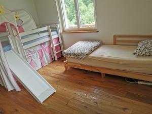a small bedroom with a bunk bed and a bunk bed at Schwendi Maison in Mels +48 photos