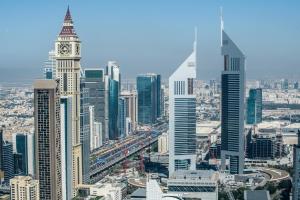 an aerial view of a city with a clock tower at Dream Inn Apartments - Index Tower in Dubai