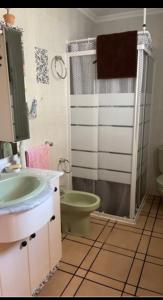 a bathroom with a sink and a toilet and a shower at Villa Irene in Gandía