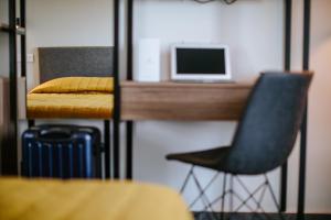a bedroom with a desk and a chair and a bed at Cosmo Napa Boutique Hotel in Ayia Napa