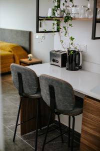 a kitchen counter with two chairs and a appliance on it at Cosmo Napa Boutique Hotel in Ayia Napa