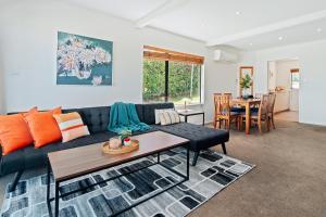 a living room with a couch and a table at Town Centre Location with Stunning View - Unit 1 in Queenstown