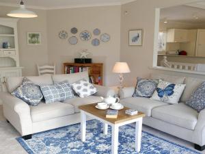 a living room with two couches and a table at Sealark in Callala Bay