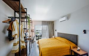 a bedroom with a yellow bed in a room at Cosmo Napa Boutique Hotel in Ayia Napa