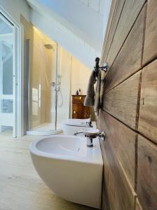 uma casa de banho com um lavatório e 2 WC em Loft Naturalpina Dolomiti Farm em Belluno