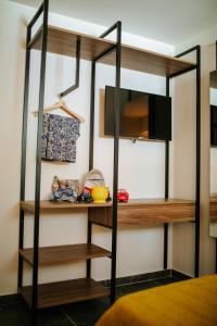 a loft bed with wooden shelves in a room at Cosmo Napa Boutique Hotel in Ayia Napa