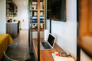 a laptop computer sitting on a wooden desk in a room at Cosmo Napa Boutique Hotel in Ayia Napa