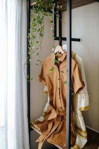 a room with a rack with clothes on it at Cosmo Napa Boutique Hotel in Ayia Napa