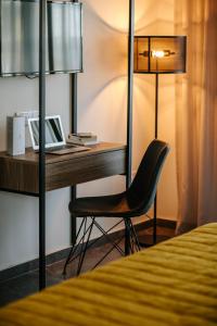 a desk with a laptop and a chair in a hotel room at Cosmo Napa Boutique Hotel in Ayia Napa