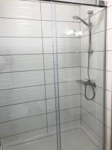 a bathroom with a shower with a glass door at Apartamento Faro in Morro del Jable