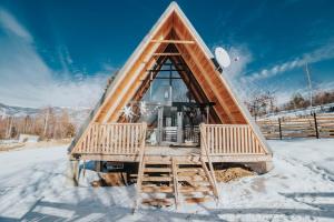 a igloo house with two chairs in the snow at Harmony Villa Lupeni Straja in Lupeni