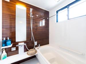 a bathroom with a bath tub and a window at Sea Stay Okinawa in Onna +51 photos