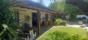 a house with a covered porch with a yard at Potties Guesthouse in De Aar